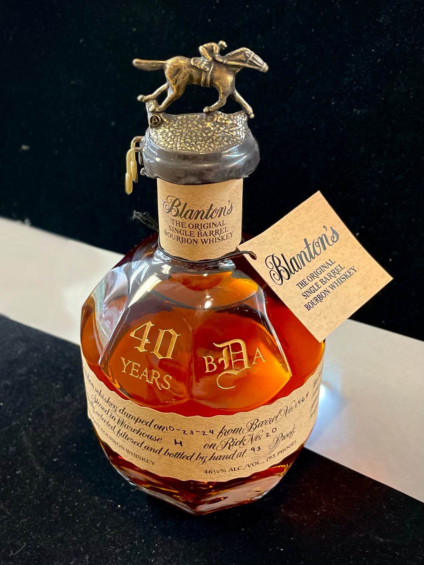 Personalized bottle of Blanton's bourbon whiskey with decorative cap on a dark background
